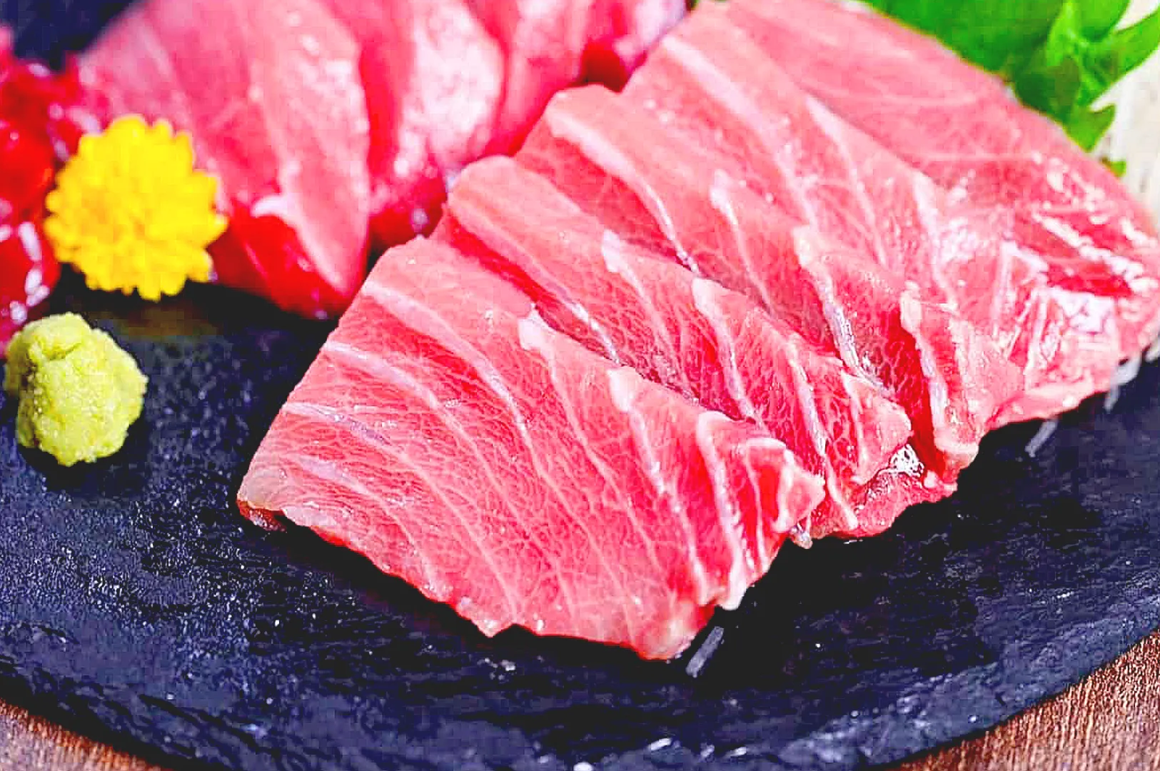 Thick slices of fatty tuna sashimi served with wasabi.