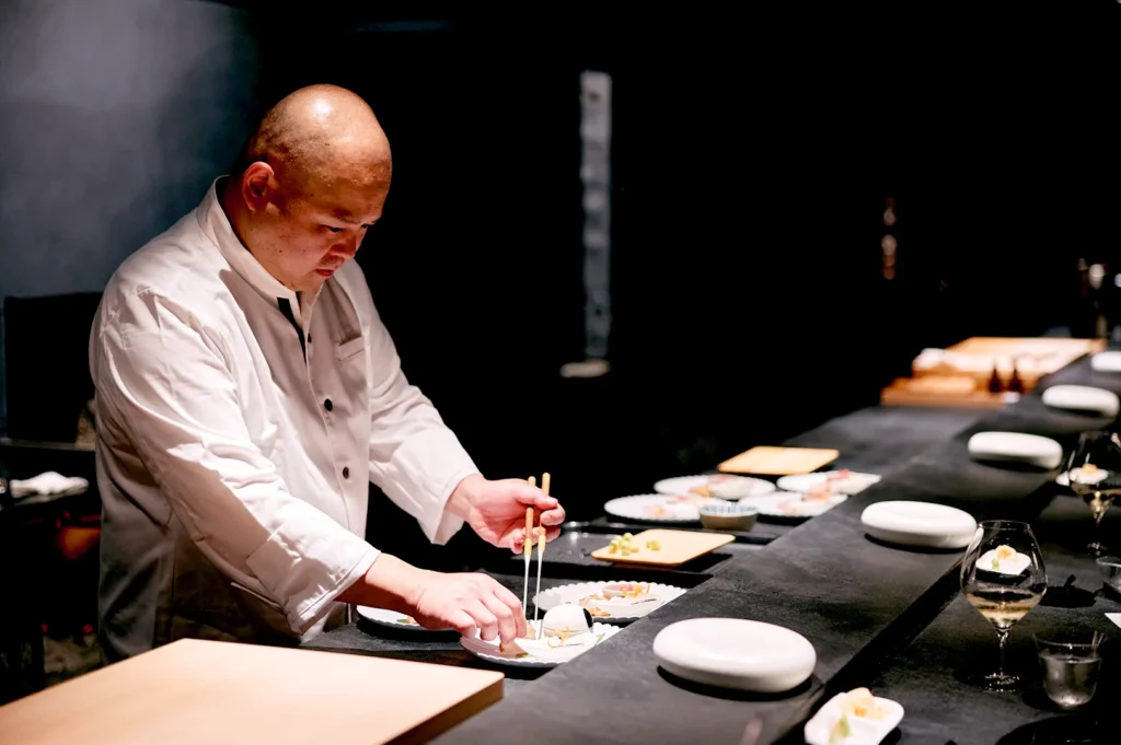 Chef preparing omakase sushi at fine dining Japanese restaurant