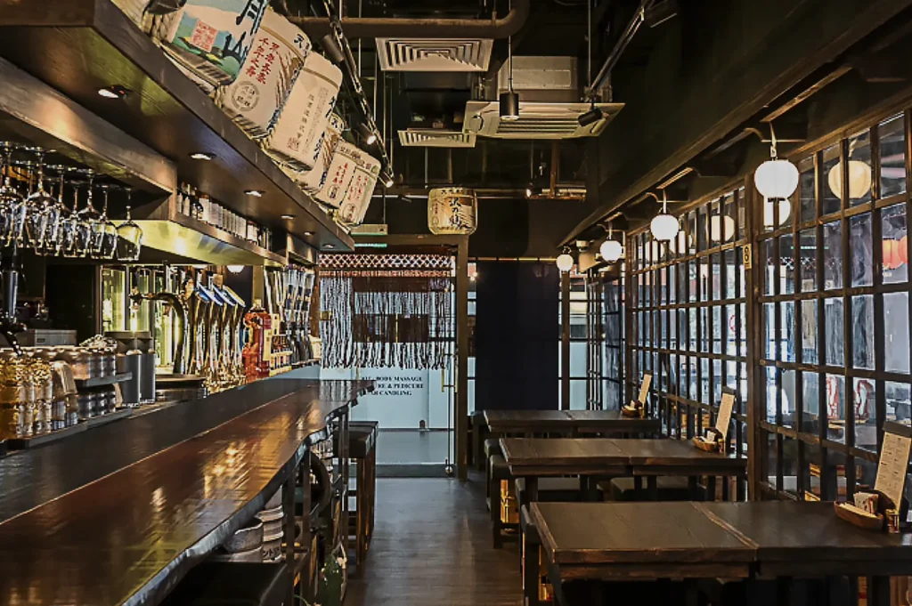 Japanese izakaya dining interior with bar counter and tables
