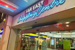 Far East Shopping Centre Orchard Road Singapore entrance at night, retro mall exterior with neon signage near hidden izakaya spots