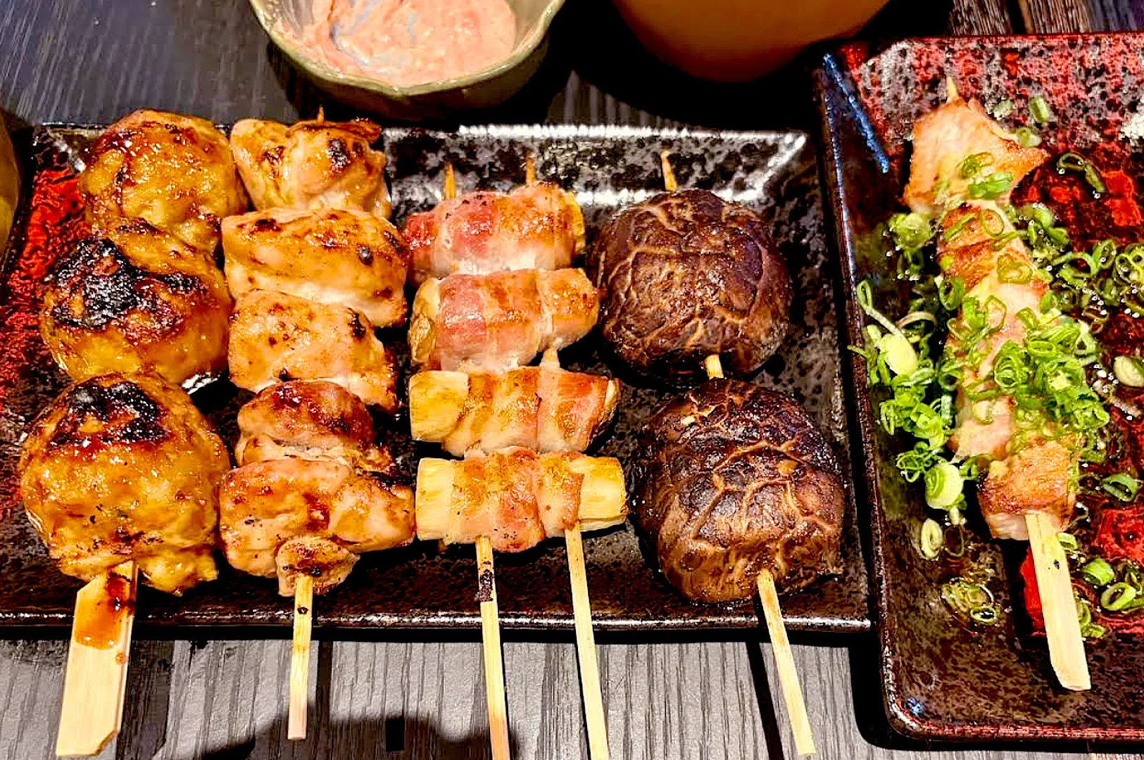 Kukai Izakaya Orchard Towers yakitori skewers Singapore featuring tsukune, pork belly, and mushrooms on a charcoal grill