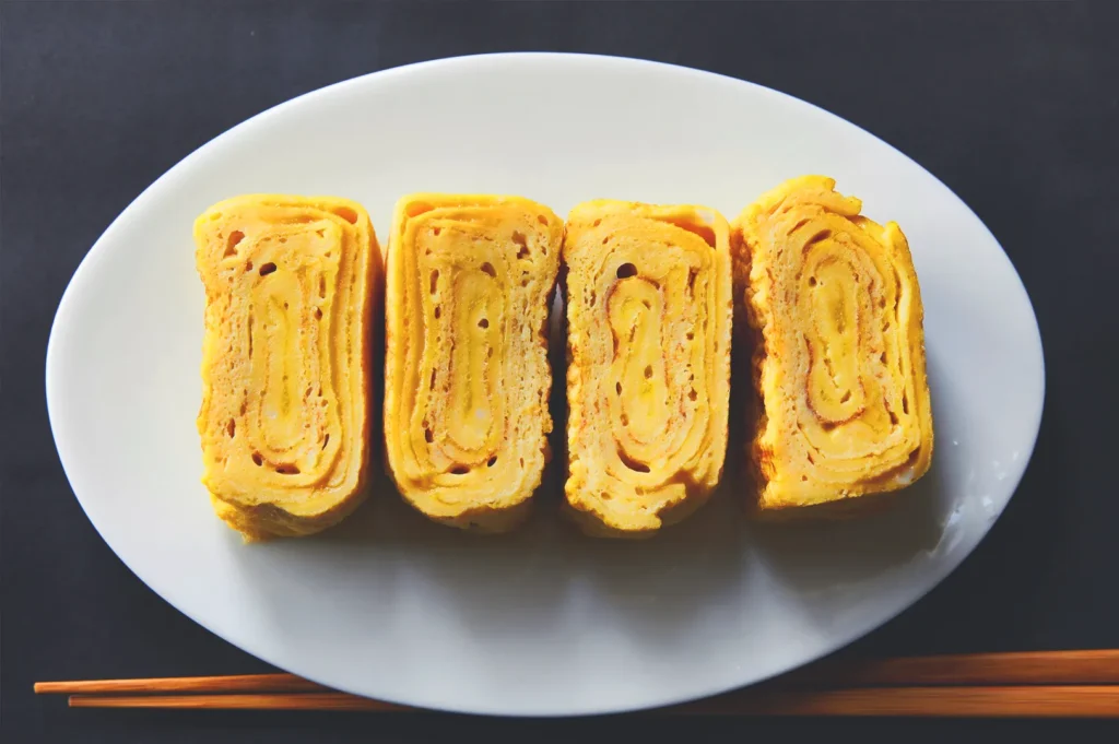 Tamagoyaki Japanese omelette slices on a plate, simple izakaya dish with soft layered texture