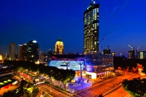 Singapore Orchard Road skyline at night with illuminated mall and city traffic near Somerset dining district
