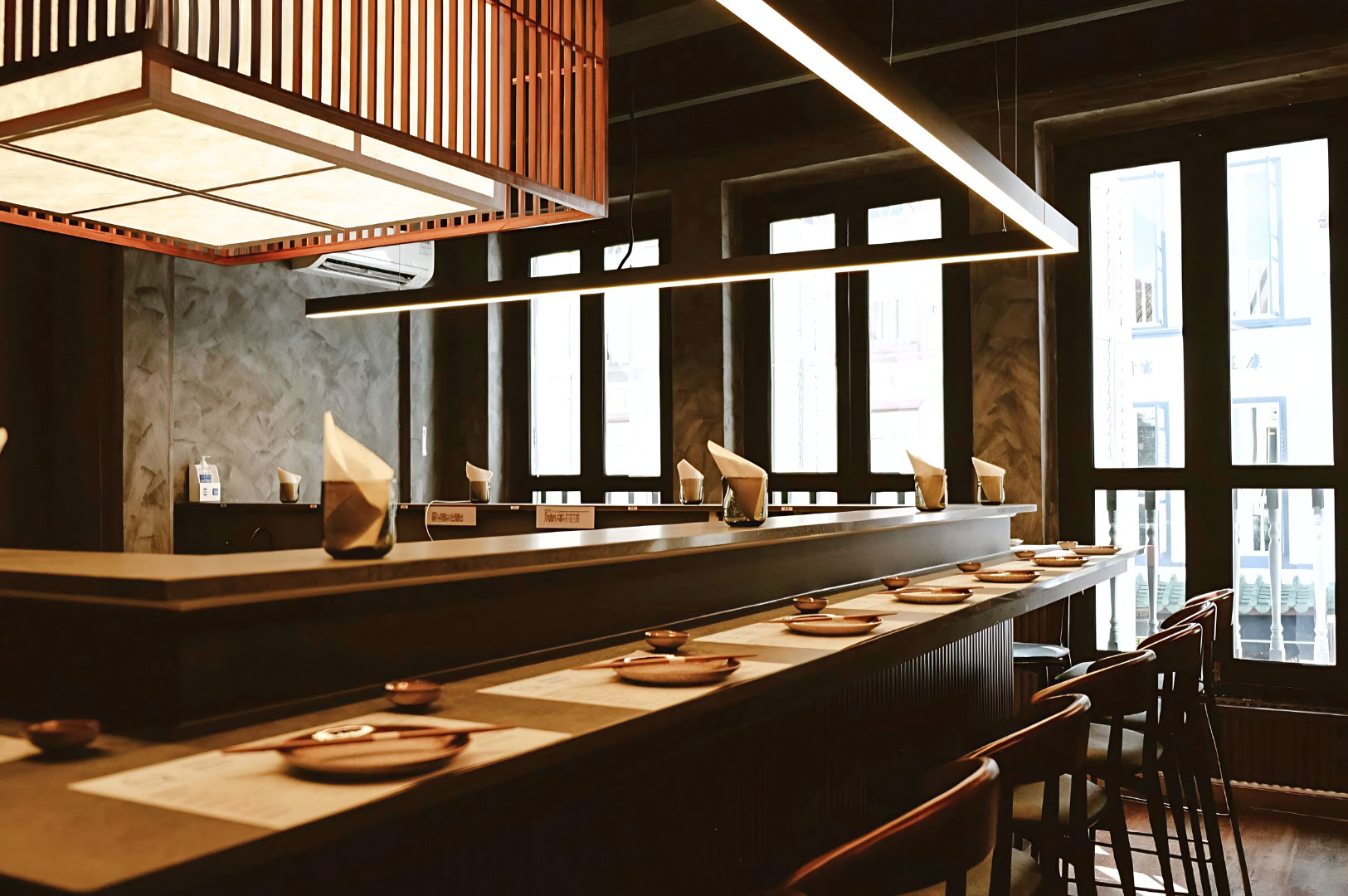 Modern Japanese handroll bar interior with counter seating and minimalist Tokyo-inspired dining space in Singapore CBD