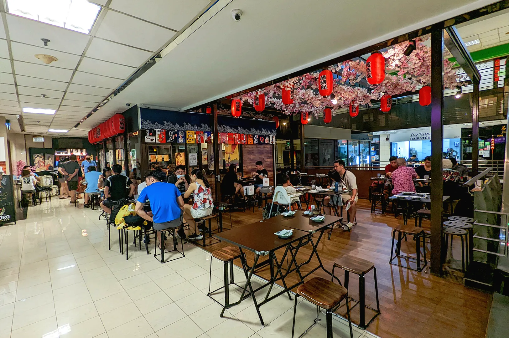 busy izakaya restaurant in Singapore with diners seated at tables casual Japanese dining experience