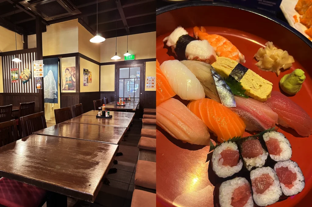Japanese dining room with wooden tables and assorted sushi on red lacquer plate.