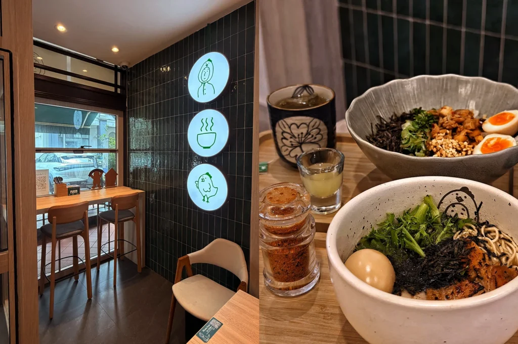 Ramen shop interior with illuminated signs and two ramen bowls with soft-boiled eggs and nori.