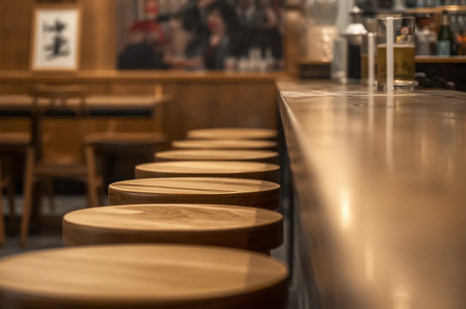 Izakaya counter seats with dishes visible in background.