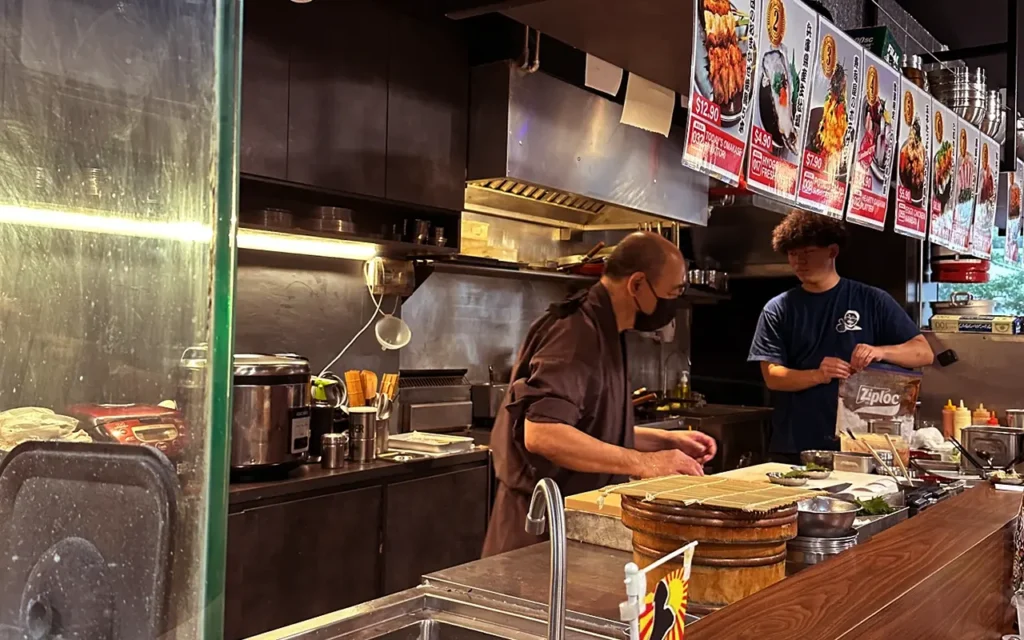 Chef preparing food at izakaya counter