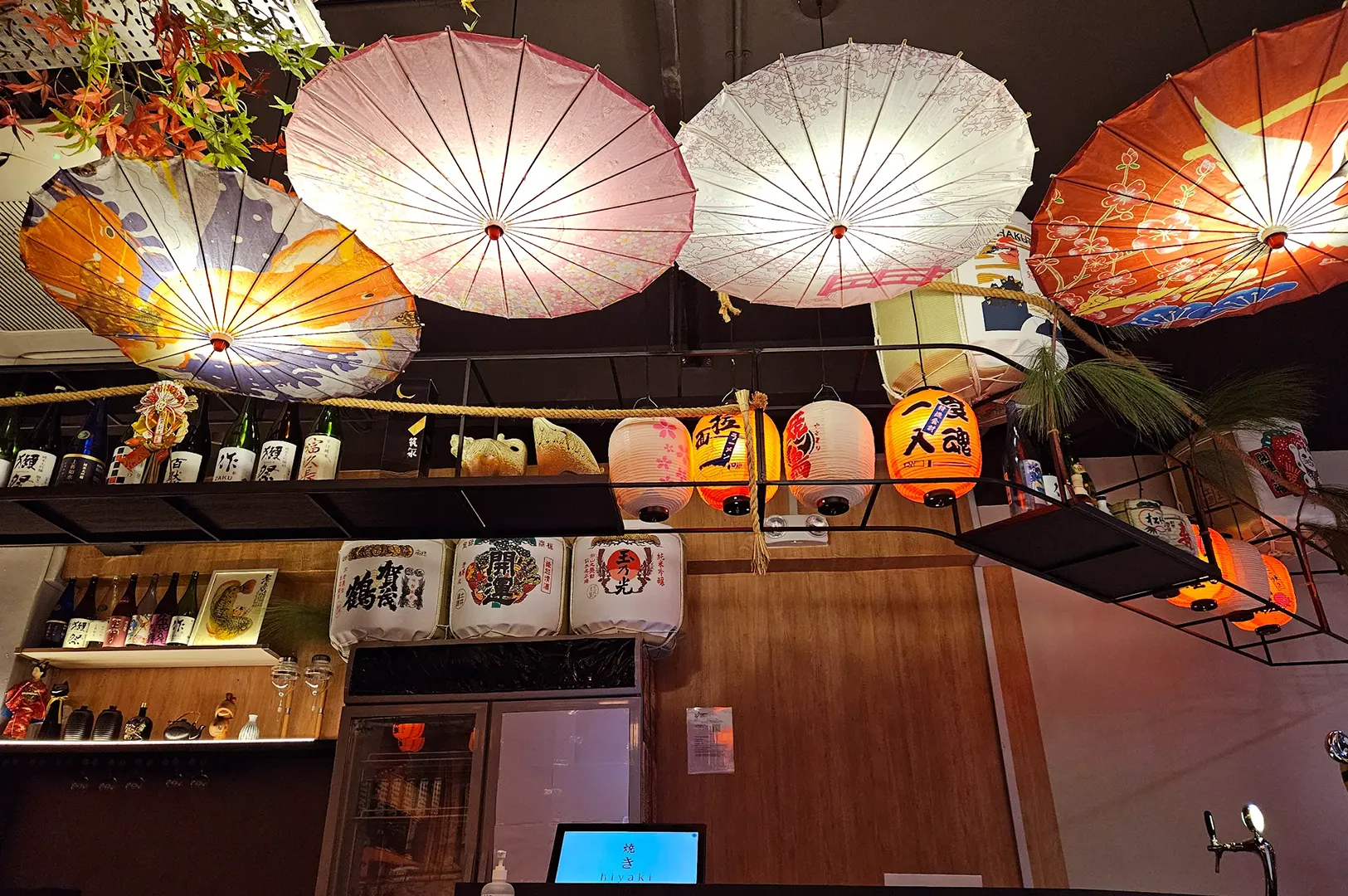 Hiyaki Yakitori Izakaya Bar interior with colorful paper umbrellas hanging from the ceiling.