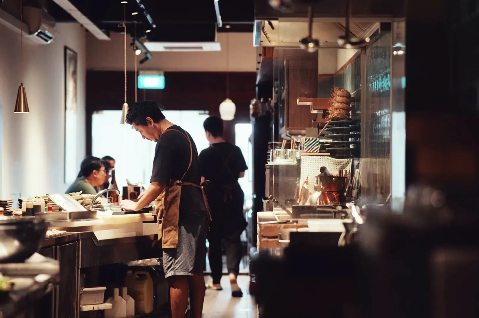 Kitchen staff at work inside HEARTH Irori & Oden Izakaya.