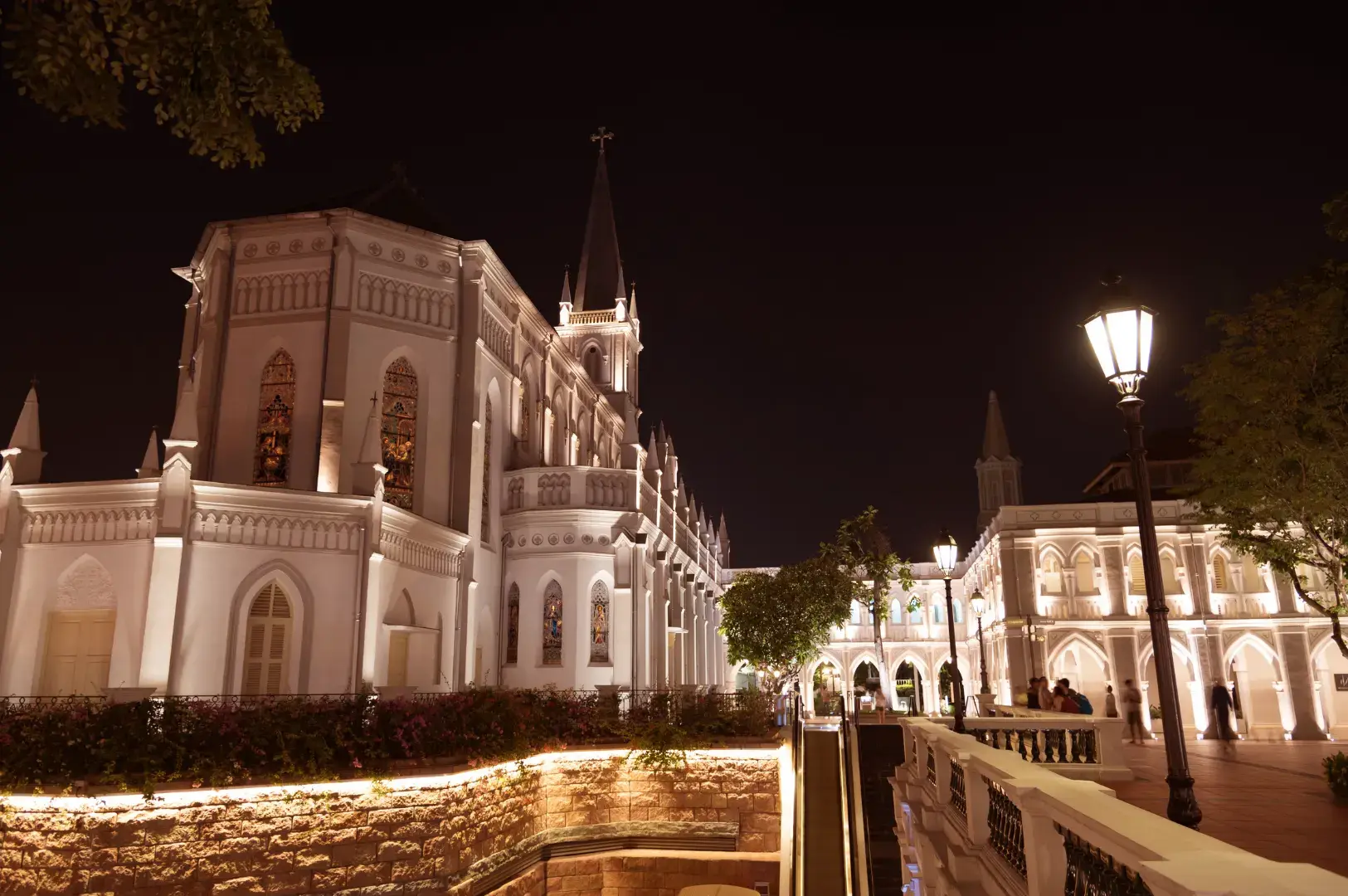 CHIJMES white Gothic chapel illuminated at night with courtyard and street lamp
